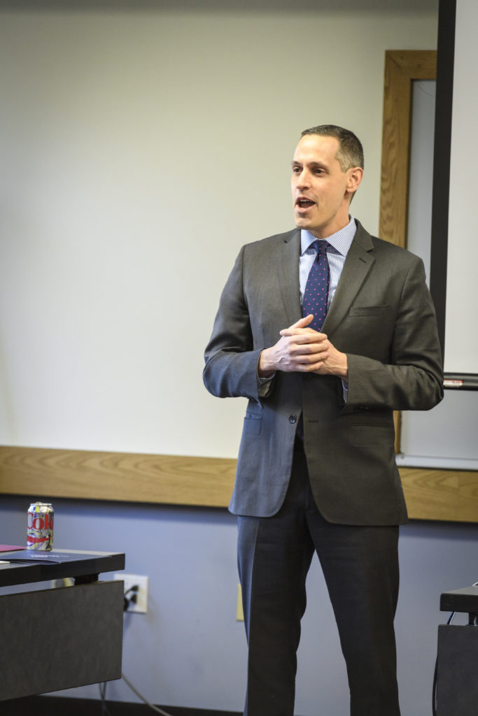 Mike Castrilli presenting in front of white board